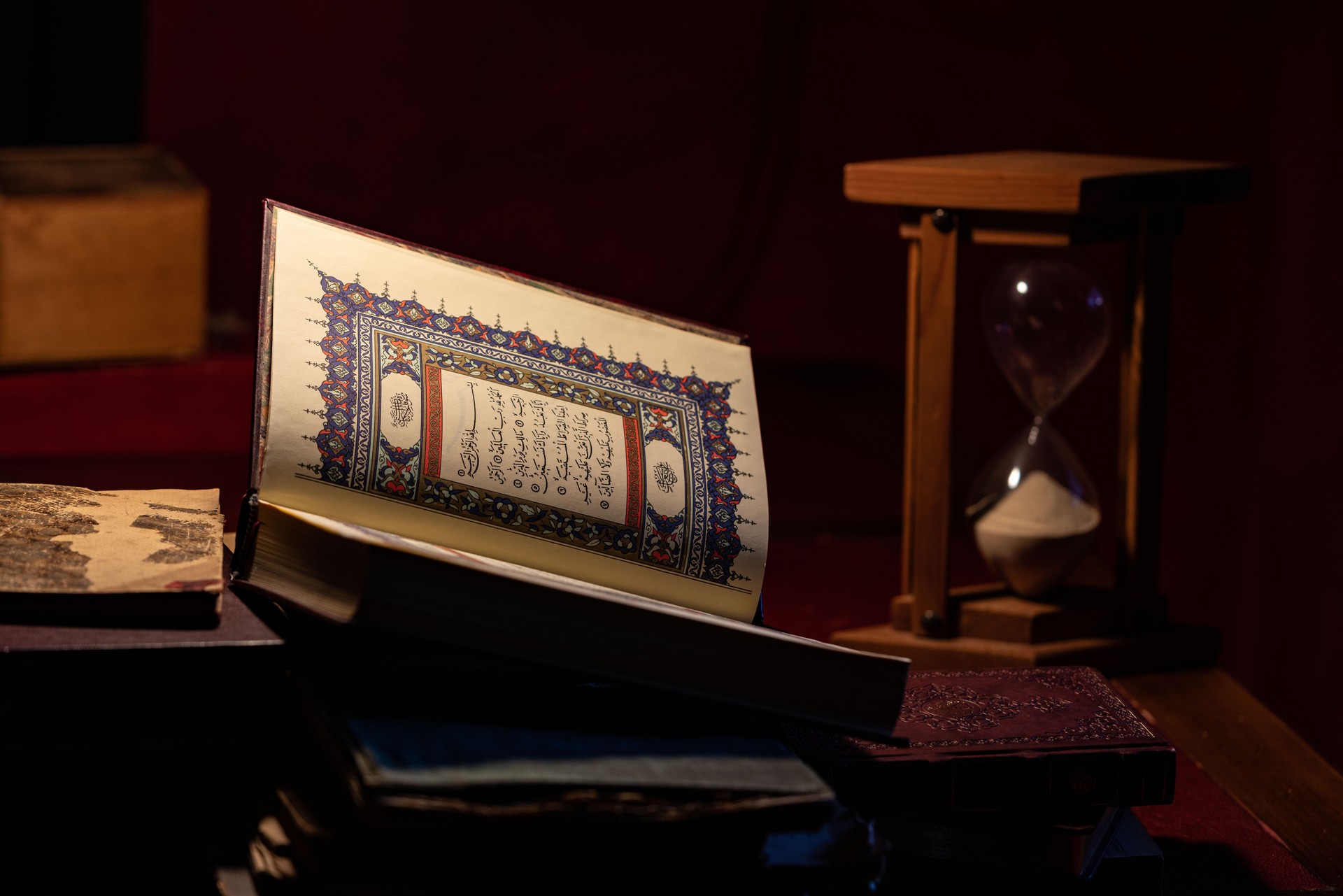 Photo Of Holy Koran And Hourglass On Table